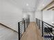 Second floor hallway features light hardwood floors and sleek, modern black metal railings at 2631 Sardis Way, Buford, GA 30519