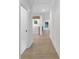 Hallway with hardwood floors, white trim and doors, and natural light at 2631 Sardis Way, Buford, GA 30519
