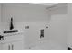 Clean laundry room featuring modern white cabinetry and marble floors at 2631 Sardis Way, Buford, GA 30519