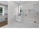 Bright laundry room with custom cabinets, a sink, and marble tile flooring at 2631 Sardis Way, Buford, GA 30519