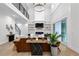 Open-concept living room featuring high ceilings, stylish furnishings, and a decorative fireplace at 2631 Sardis Way, Buford, GA 30519