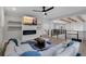 Open living room with fireplace, mounted tv, modern decor, and wood beam accents on the ceiling at 2631 Sardis Way, Buford, GA 30519