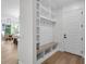 Bright mudroom featuring built-in storage, bench seating, and hooks for organization near the front door at 2631 Sardis Way, Buford, GA 30519