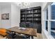 Well-appointed home office with built-in shelves, modern lighting, and a comfortable workspace at 2631 Sardis Way, Buford, GA 30519