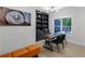 Home office with built-in shelves, a modern desk, and plenty of natural light from the window at 2631 Sardis Way, Buford, GA 30519