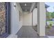 Covered porch with tiled floor, offering a welcoming entrance to the home at 2631 Sardis Way, Buford, GA 30519