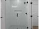 Modern shower features glass door, white tile surround, and sleek black fixtures at 2631 Sardis Way, Buford, GA 30519