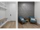 Inviting sitting area featuring a geometric accent wall, comfortable seating, and built-in storage at 2631 Sardis Way, Buford, GA 30519