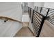Staircase with light wood treads and horizontal black metal railing provides a modern touch at 2631 Sardis Way, Buford, GA 30519