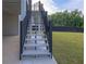 Exterior staircase with black metal railings and gray painted steps at 2631 Sardis Way, Buford, GA 30519