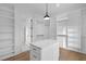 Spacious walk-in closet with built-in shelving and custom island with countertop space at 2631 Sardis Way, Buford, GA 30519