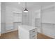 Spacious walk-in closet with built-in shelving and custom island with countertop space at 2631 Sardis Way, Buford, GA 30519