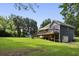 This backyard offers a large grassy area, a deck, and a playground, perfect for outdoor activities at 735 Poplar Rd, Dallas, GA 30157