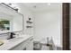 Modern bathroom featuring a white vanity, black fixtures, shelves, and tile floors at 735 Poplar Rd, Dallas, GA 30157