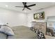 Relaxing main bedroom features a ceiling fan, mounted television and a dresser with mirror at 735 Poplar Rd, Dallas, GA 30157