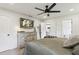 Bright bedroom with a TV, ceiling fan, dresser, and ensuite bathroom entrance at 735 Poplar Rd, Dallas, GA 30157