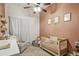 Cozy Bedroom with a crib, chair, and charming decor at 735 Poplar Rd, Dallas, GA 30157