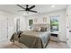 A well-lit bedroom with two windows, fan, and neutral tones at 735 Poplar Rd, Dallas, GA 30157