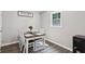 Cozy dining room with gray plank floors, window and table set for four at 735 Poplar Rd, Dallas, GA 30157