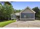Charming home boasts a well-manicured lawn, blue siding, stone accents, and a long driveway leading to the residence at 735 Poplar Rd, Dallas, GA 30157