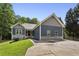 Charming home boasts a well-manicured lawn, blue siding, stone accents, and a long driveway leading to the residence at 735 Poplar Rd, Dallas, GA 30157