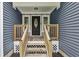 Front porch and entry features wood railings, gray stone, and a black door with an oval window at 735 Poplar Rd, Dallas, GA 30157