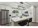 Bright kitchen with white cabinets, stainless appliances and a center island with seating at 735 Poplar Rd, Dallas, GA 30157