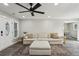 Living room features a light-colored sectional sofa with decorative pillows and a patterned rug on vinyl floors at 735 Poplar Rd, Dallas, GA 30157