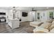Living room and kitchen featuring stainless appliances, island with seating, and light-colored sectional at 735 Poplar Rd, Dallas, GA 30157
