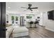 Open floor plan living room and kitchen featuring stainless appliances, island with seating, and light-colored sectional at 735 Poplar Rd, Dallas, GA 30157