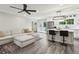 Open floor plan living room and kitchen featuring stainless appliances, island with seating, and light-colored sectional at 735 Poplar Rd, Dallas, GA 30157
