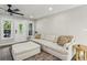 Bright living room features a modern ceiling fan, new windows and a comfortable, neutral sectional sofa at 735 Poplar Rd, Dallas, GA 30157