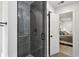 Modern walk-in shower with glass enclosure and gray tile and view to bedroom at 735 Poplar Rd, Dallas, GA 30157