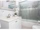 Bathroom with a single sink vanity and a tiled shower-tub combination with sliding glass doors at 791 E Main Street, Canton, GA 30114