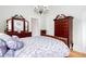 This bedroom features a sleigh bed, dark wooden dressers, and hardwood floors at 791 E Main Street, Canton, GA 30114