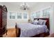 Cozy bedroom features an ornate chandelier and three bright windows at 791 E Main Street, Canton, GA 30114
