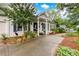 Well-maintained home with a charming porch, manicured landscaping, and a paved driveway adding to its appeal at 791 E Main Street, Canton, GA 30114