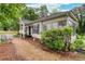Charming home with a well-manicured yard, porch, and lots of greenery, creating a welcoming entrance at 791 E Main Street, Canton, GA 30114