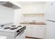 White kitchen with vintage appliances, ample cabinet space, and laminate countertops at 791 E Main Street, Canton, GA 30114