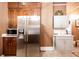 Compact kitchen featuring a stainless steel refrigerator, microwave and white countertop space at 791 E Main Street, Canton, GA 30114
