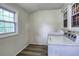 Bright laundry room featuring wood-look vinyl flooring and two large windows at 791 E Main Street, Canton, GA 30114