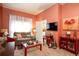 This living room features peach colored walls, neutral carpet, and a comfortable sofa at 791 E Main Street, Canton, GA 30114