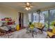 Cozy sunroom featuring ample natural light, wicker furniture, and a decorative rug for a peaceful retreat at 791 E Main Street, Canton, GA 30114