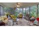 Bright sunroom with large windows, ceiling fan, comfortable seating, and stylish decor creating a relaxing atmosphere at 791 E Main Street, Canton, GA 30114
