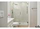 Bathroom featuring modern shower with glass door, sleek fixtures and a white vanity at 119 Laurel Mill Ct, Roswell, GA 30076