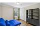 Bedroom with hardwood floors, storage closet and blue futon at 119 Laurel Mill Ct, Roswell, GA 30076