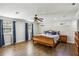 Spacious bedroom featuring hardwood floors, natural light, and comfortable decor at 119 Laurel Mill Ct, Roswell, GA 30076