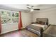 Bedroom featuring hardwood floors, ceiling fan, large window, and neutral decor at 119 Laurel Mill Ct, Roswell, GA 30076