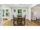 Bright dining room featuring hardwood floors, natural light, and easy access to the sunroom and other living areas at 119 Laurel Mill Ct, Roswell, GA 30076