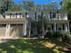 Inviting two-story home with a charming pergola entrance, attached two-car garage, and well-maintained landscaping at 119 Laurel Mill Ct, Roswell, GA 30076